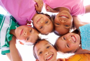 Five children smiling together.