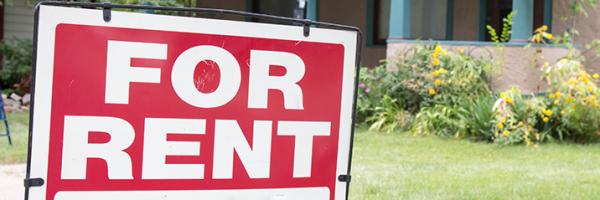 "For Rent" sign in a yard